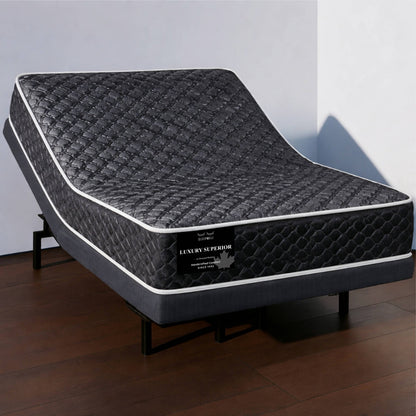 "Luxury Superior mattress in dark quilted diamond-stitch fabric on an adjustable bed base, shown from a corner angle — Sleepwell Bedding."