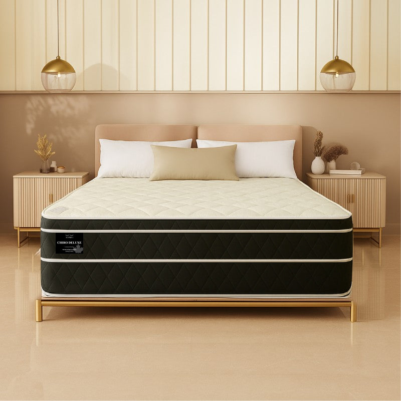 Chiro Deluxe mattress front view on gold-frame bed in warm tan-toned bedroom - buy in Winnipeg