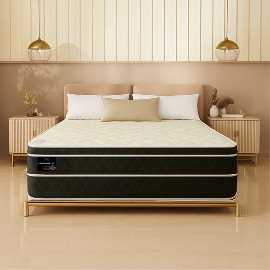 Chiro Deluxe mattress front view on gold-frame bed in warm tan-toned bedroom - buy in Winnipeg