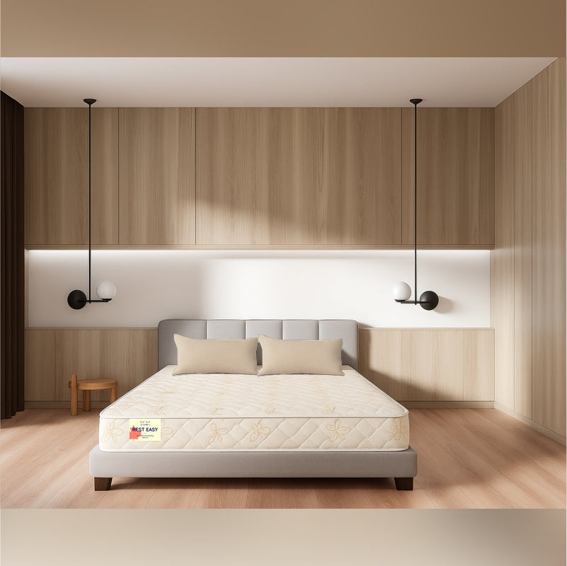 Rest Easy mattress front view in wooden panel bedroom with pendant lights