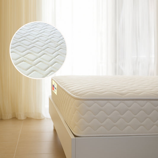 Rest Easy mattress corner view with wave-quilted fabric on white bed frame - buy in Winnipeg
