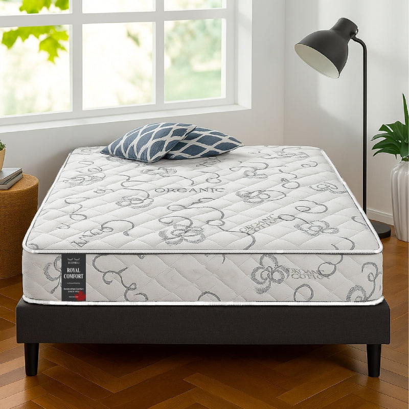 SleepWell Royal Comfort organic cotton mattress on dark bed frame in bright bedroom