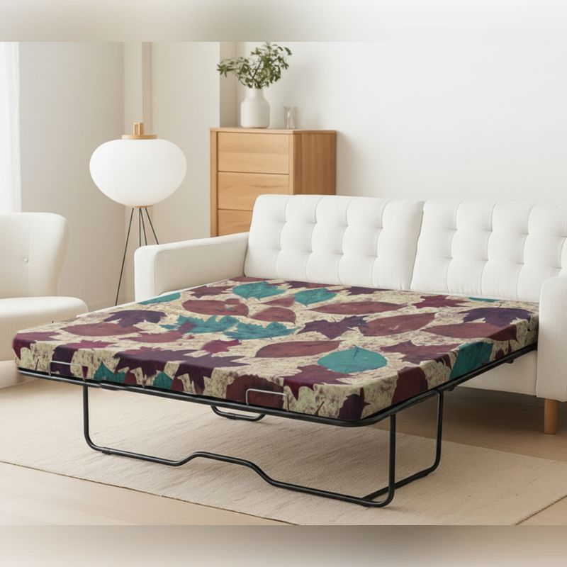 Foldable sofa bed mattress with abstract print, set up in a living room – SleepWell