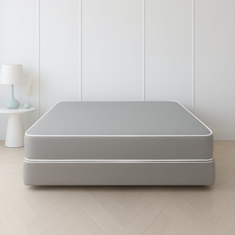 Grey mattress and box spring set in a minimal white paneled bedroom – SleepWell