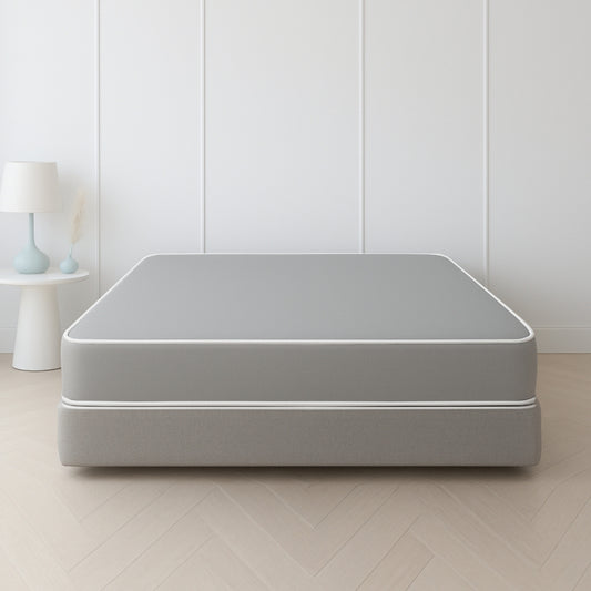 Grey mattress and box spring set in a minimal white paneled bedroom – SleepWell
