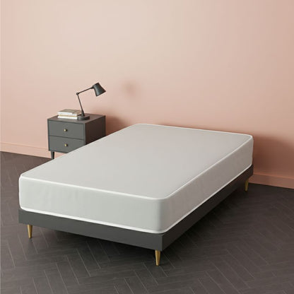 White mattress on a grey upholstered bed frame with wooden legs, in a pink bedroom setting – SleepWell